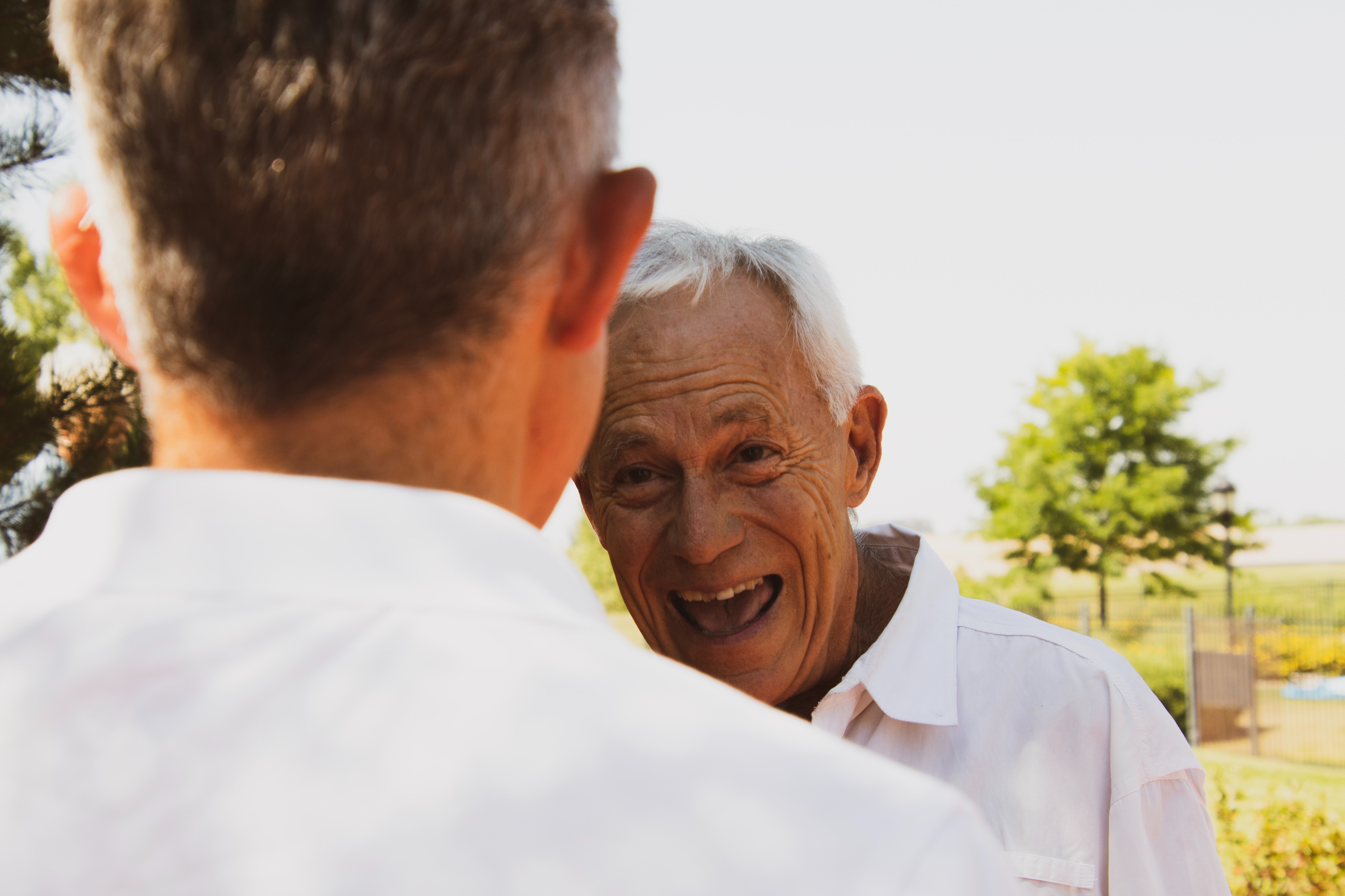 Older man greeting a younger man
