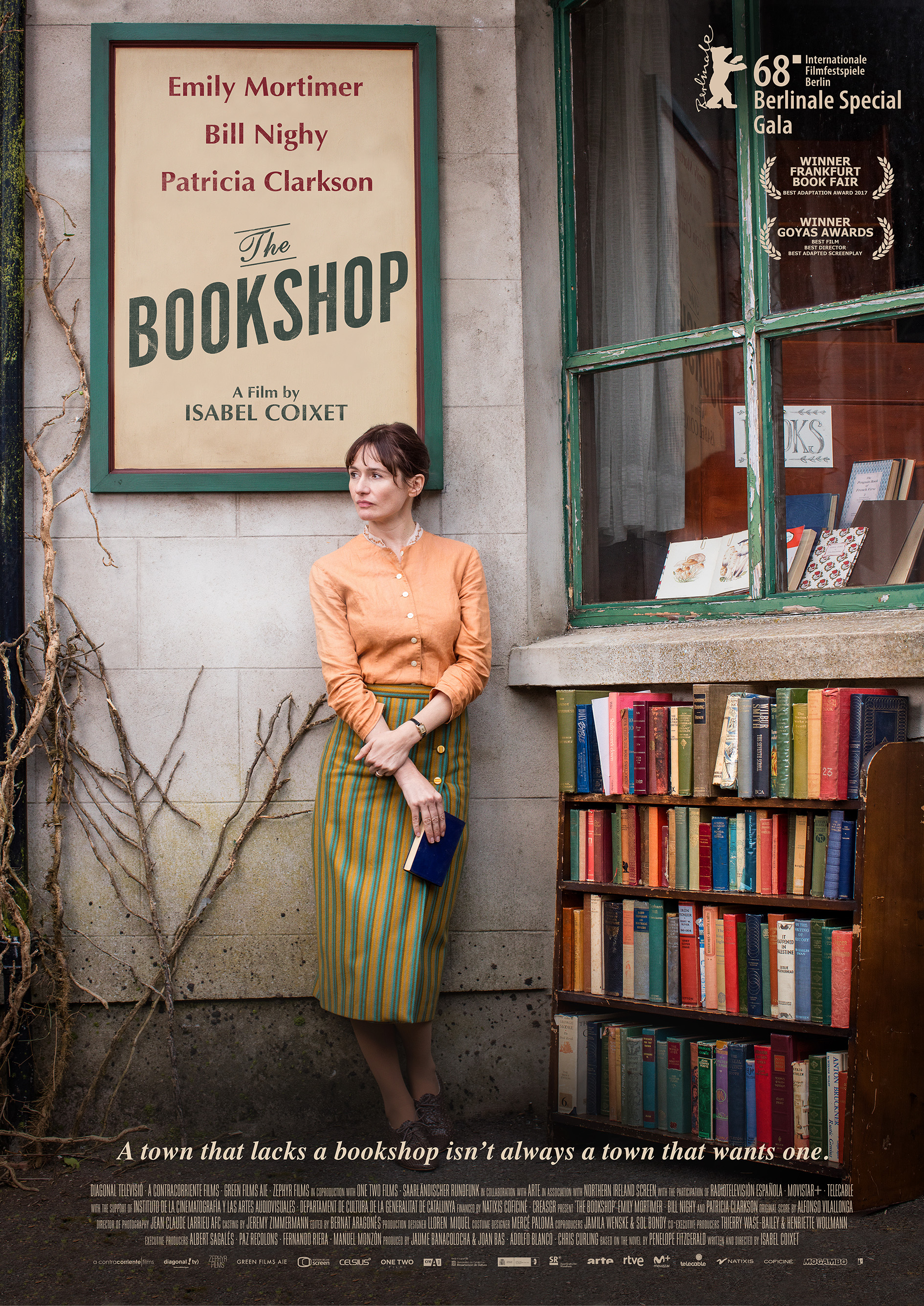 woman in front of old building with a shelf of books to her right