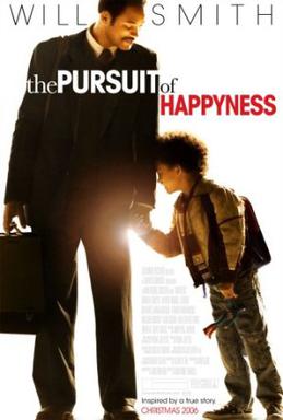 Man in suit carrying briefcase (Will Smith) holds hands in a moment of tenderness with his young son (Jaden Smith) wearing a backpack