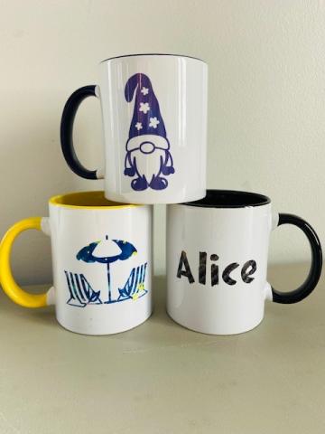 three mugs in a pyramid. one shows a beach umbrella, one a gnome, and one the name Alice