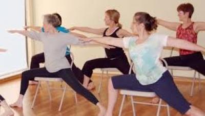 women doing yoga on chairs