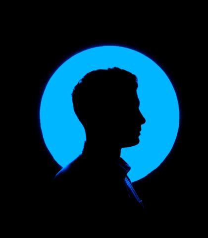 silhouette of man's head on blue background