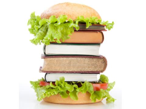 books sandwiched between burger buns and lettuce