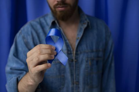 Man with dark blue prostate cancer ribbon