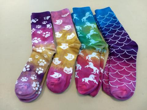 four pairs of brightly colored tie-dyed socks