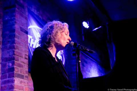 Jenny Bruce sitting at Piano