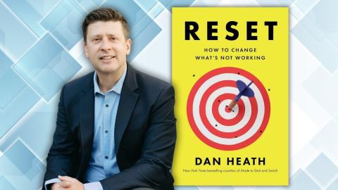 Dan next to the cover of his book with a target on the front