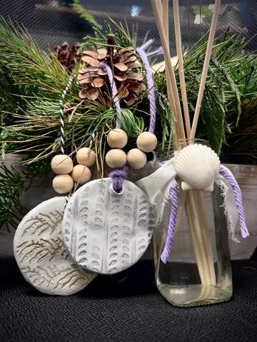 reed diffuser in front of winter plants