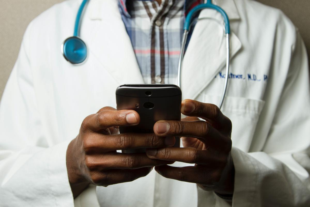 Doctor with a cellphone (National Cancer Institute)