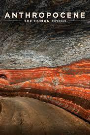 interior of cave with grey and orange stone and the text anthropocene at the top