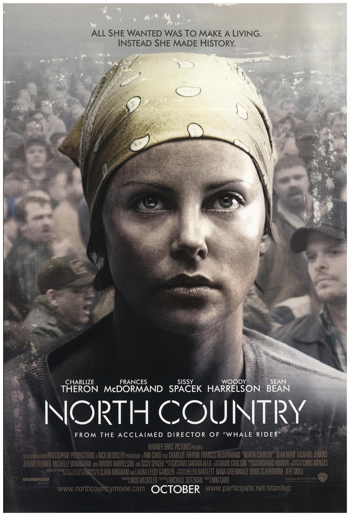 charlize theron with a yellow bandana and north country written in white letters at the bottom