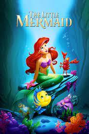 red head mermaid sitting underwater on a rock