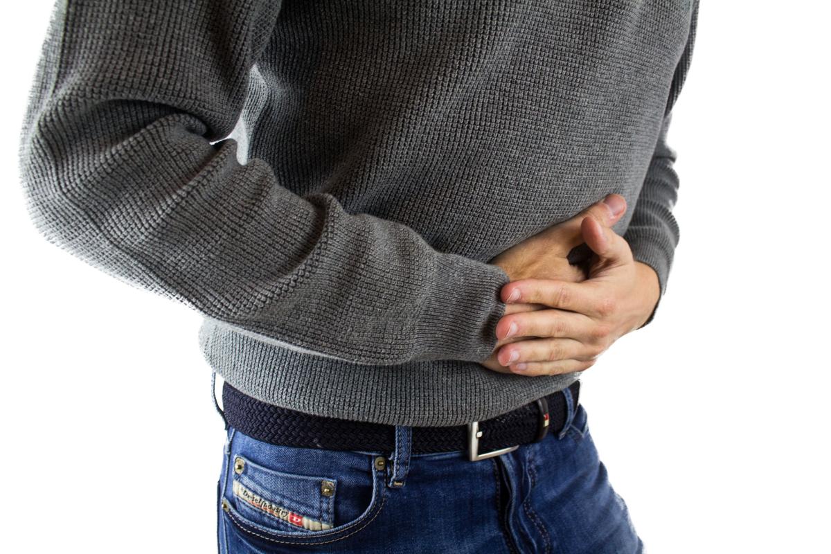 man holding stomach in pain